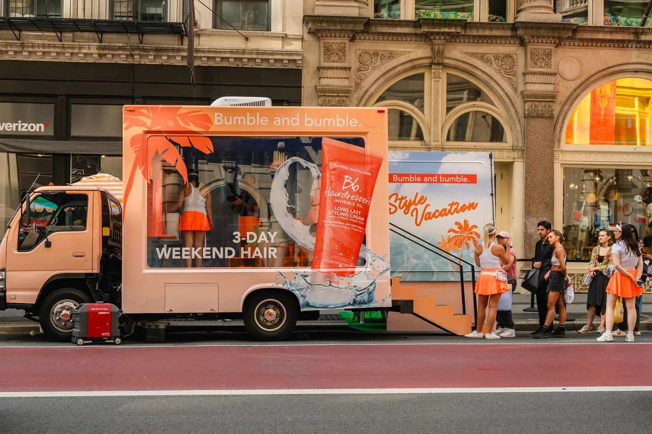 Bumble and bumble running on a glass truck at Broadway, Manhattan, New York, 2025