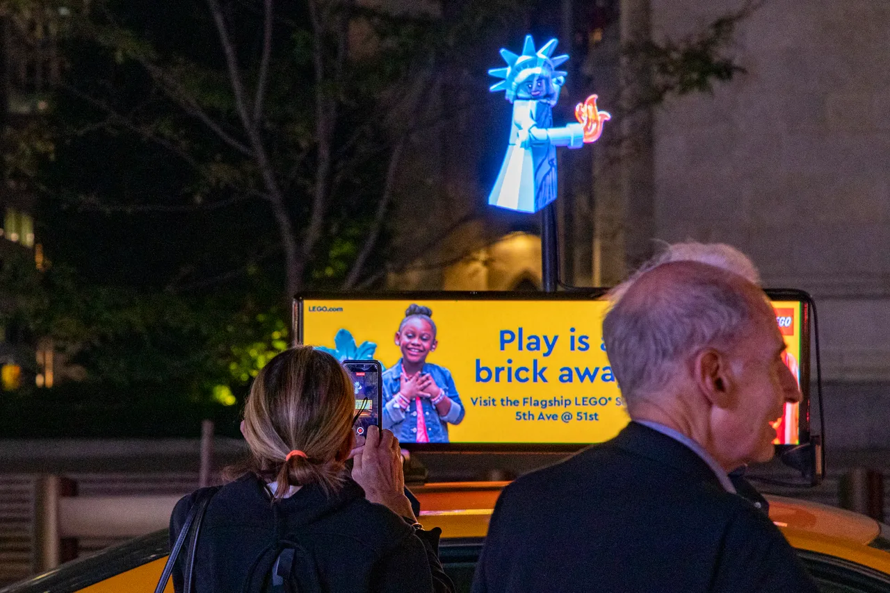 LEGO running on a hologram with digital top at Fifth Avenue at 51st, LEGO flagship, New York, 2024