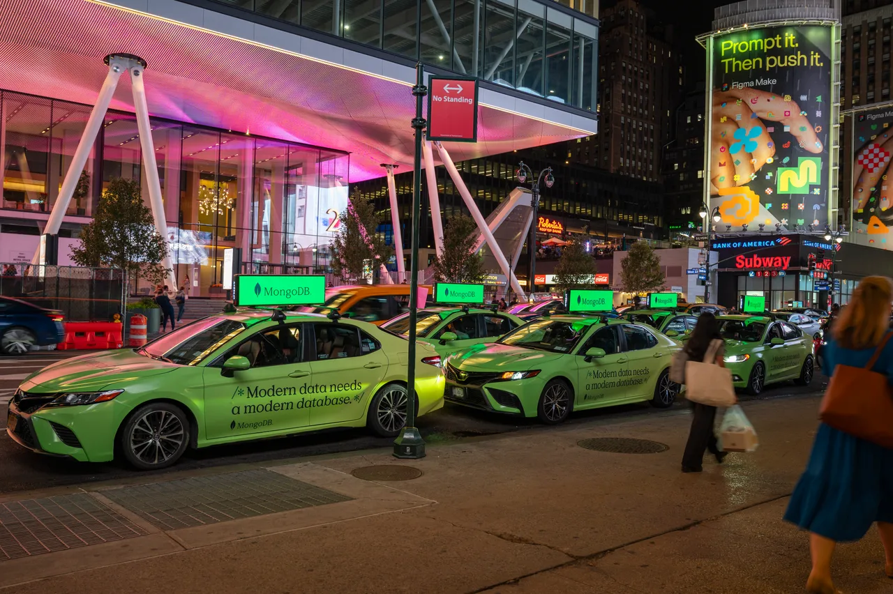 MongoDB running on a full wrap swarm with digital tops at Herald Square, New York, 2025