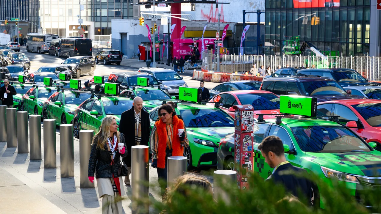 Shopify running on a 360 wrap swarm with digital tops at Javits Center, New York, 2025