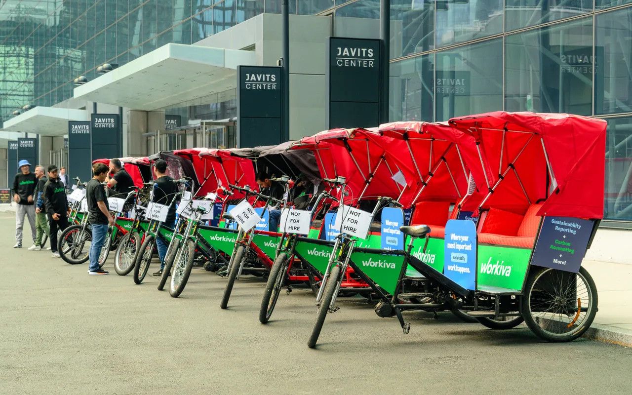 Workiva running on a wrapped pedicabs at Javits Center, New York, 2024